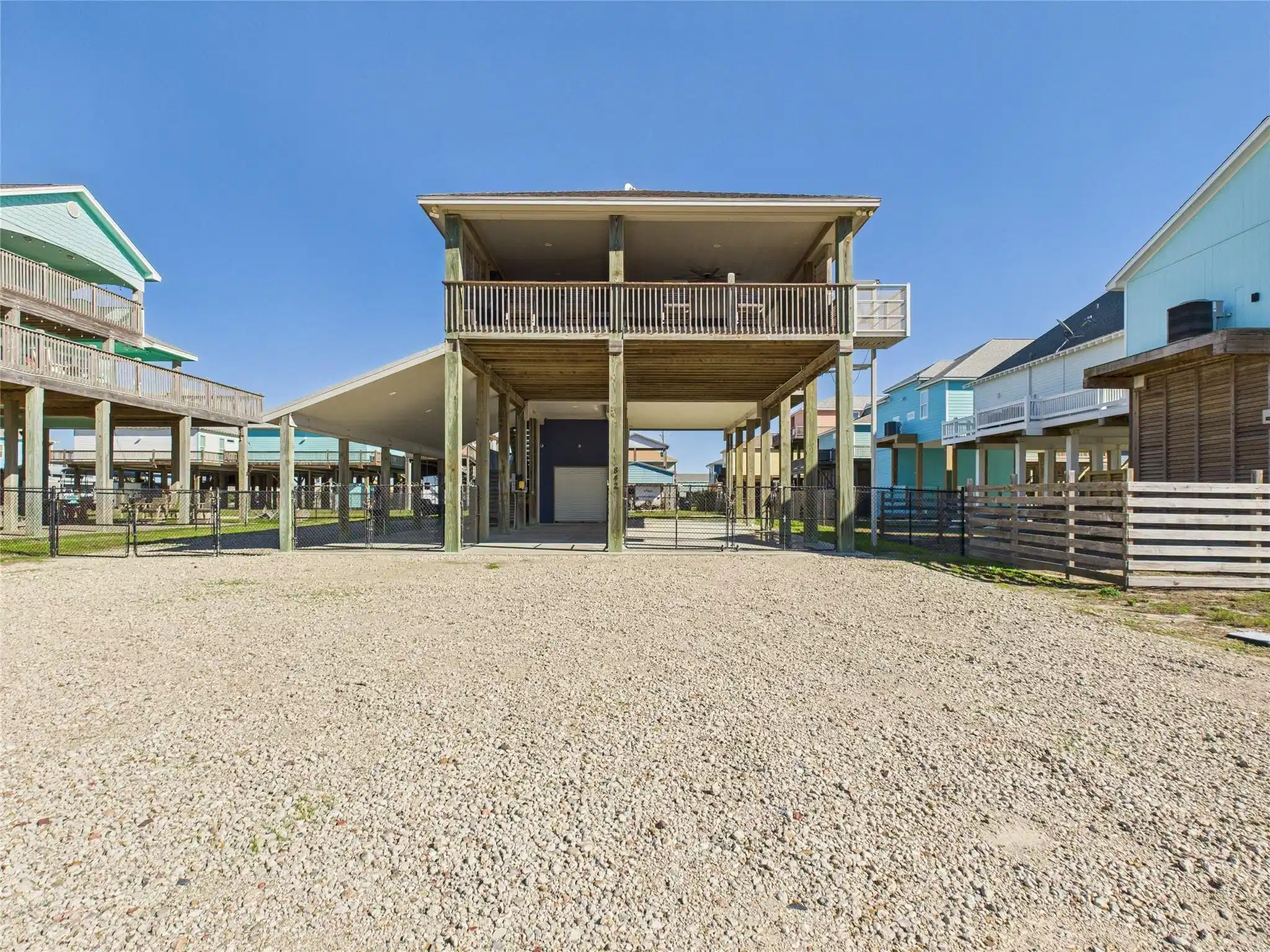 Image 1: Elevated beach house with a spacious gravel drivew