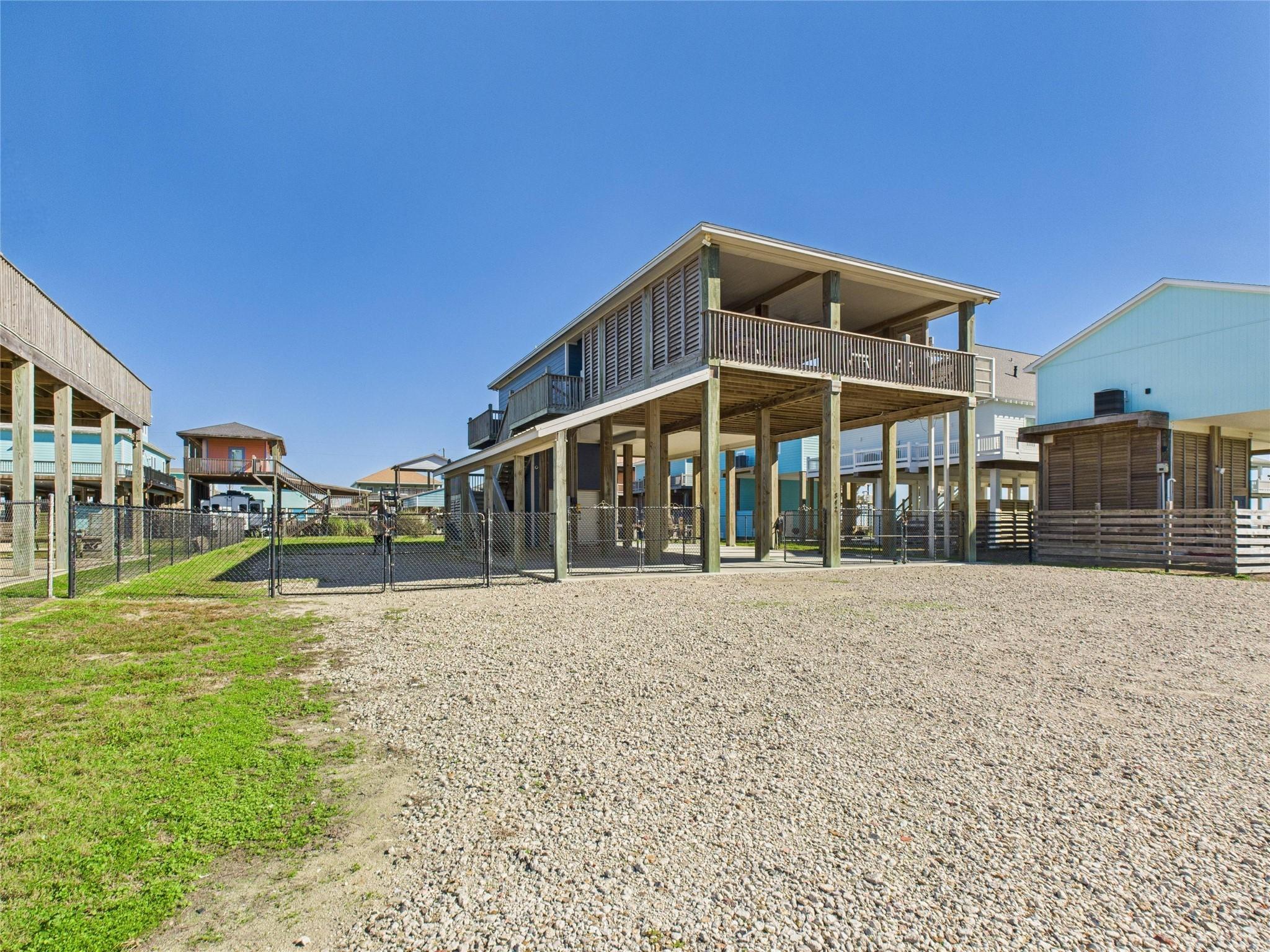 Image 3: Elevated beach-style home with a spacious wrap-aro