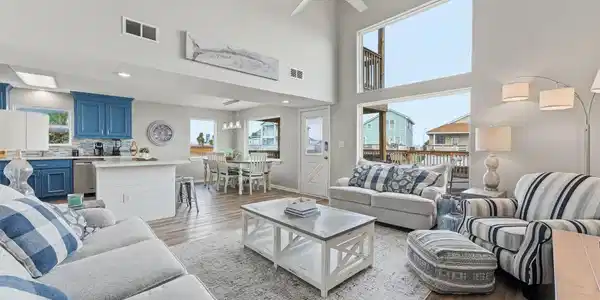 Image 4: An open-concept living area filled with natural li