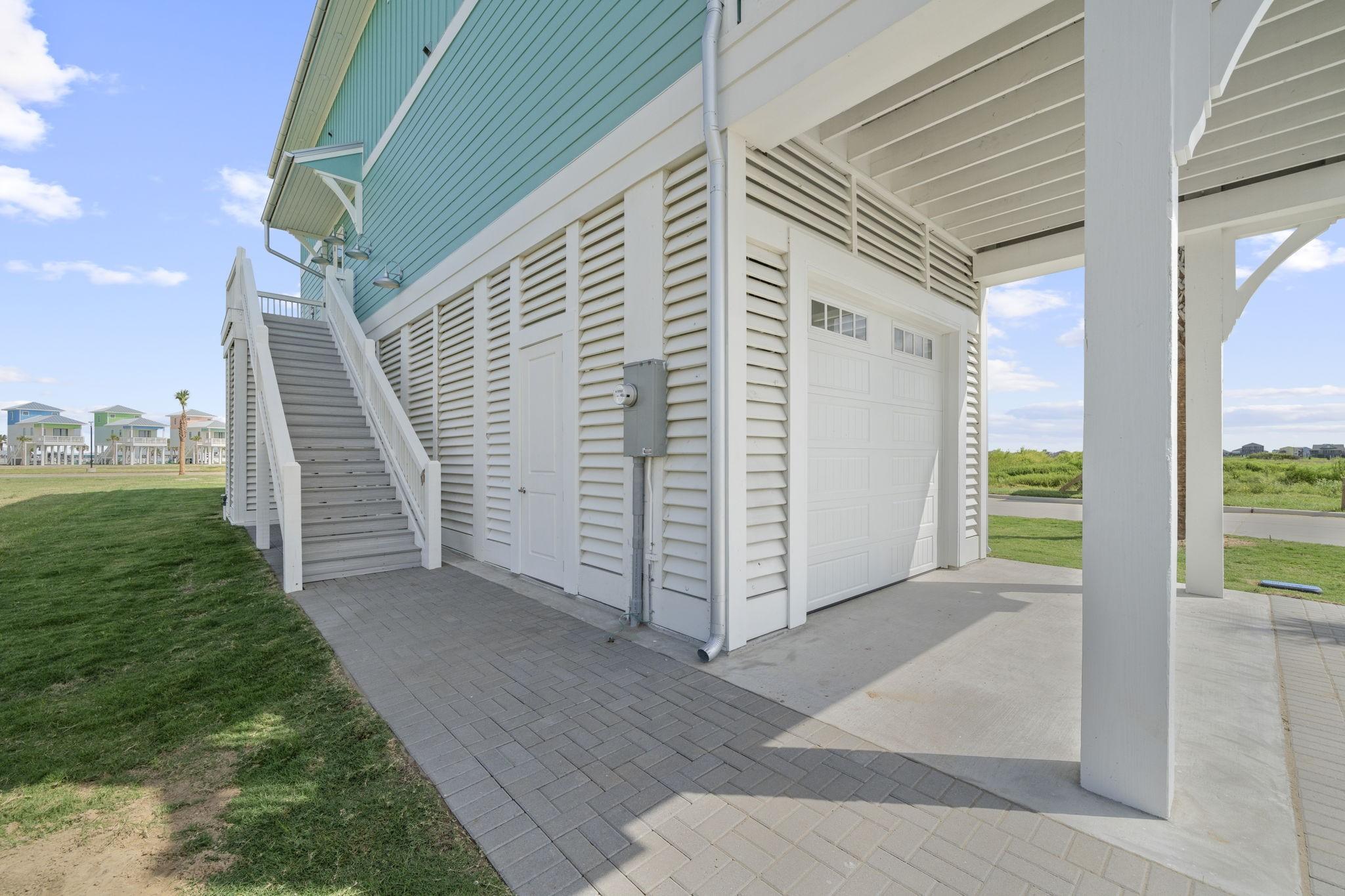 Image 4: Ground level garage with exterior staircase leadin