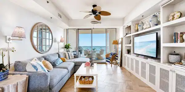 Image 2: Bright coastal living room with custom built-ins,