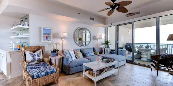 Image 3: Light-filled coastal living room with custom built
