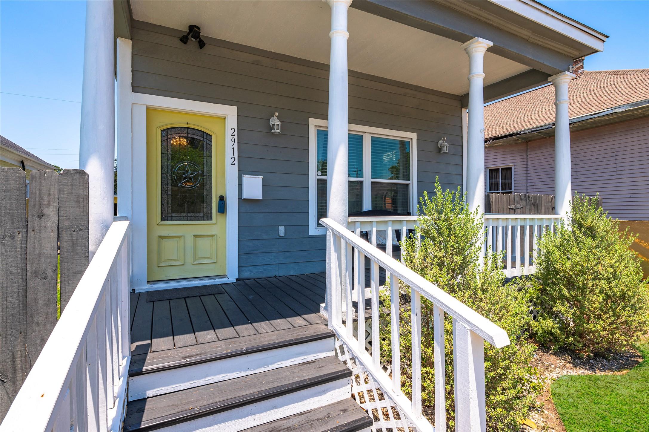 Image 3: Spacious porch area framed in classic white picket