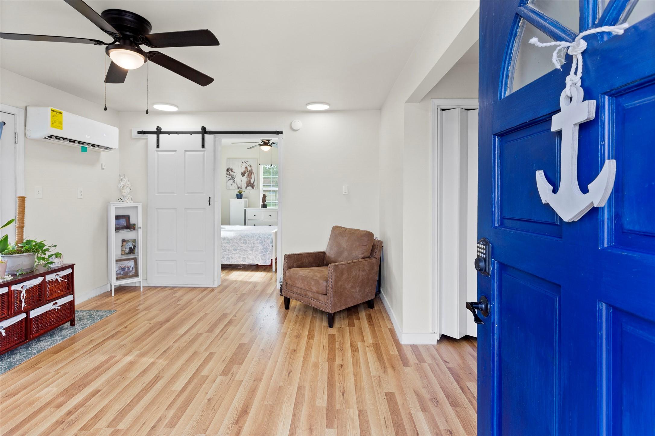 Image 3: This inviting entryway features a bright blue door