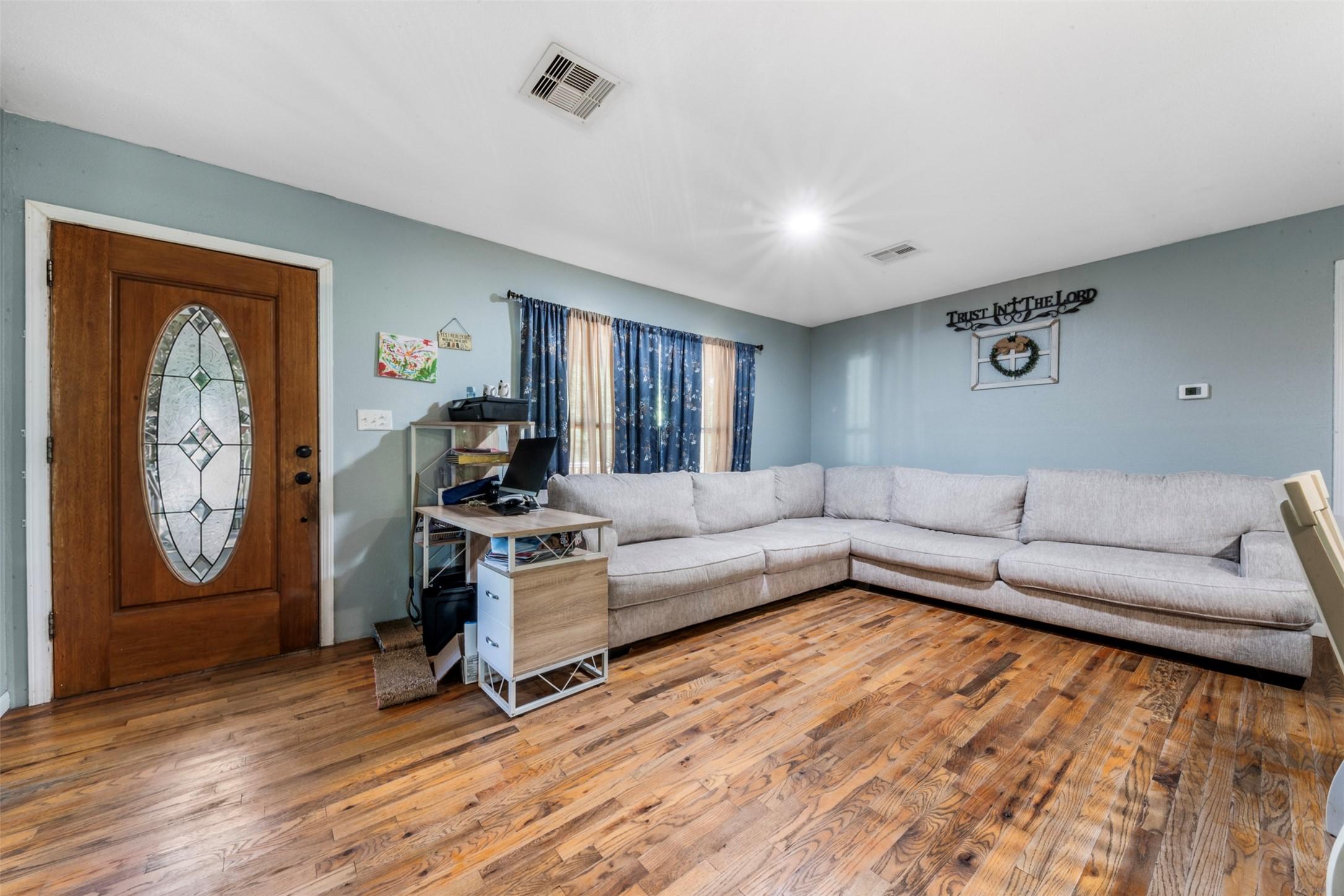 Image 3: Living room, front door entrance.
