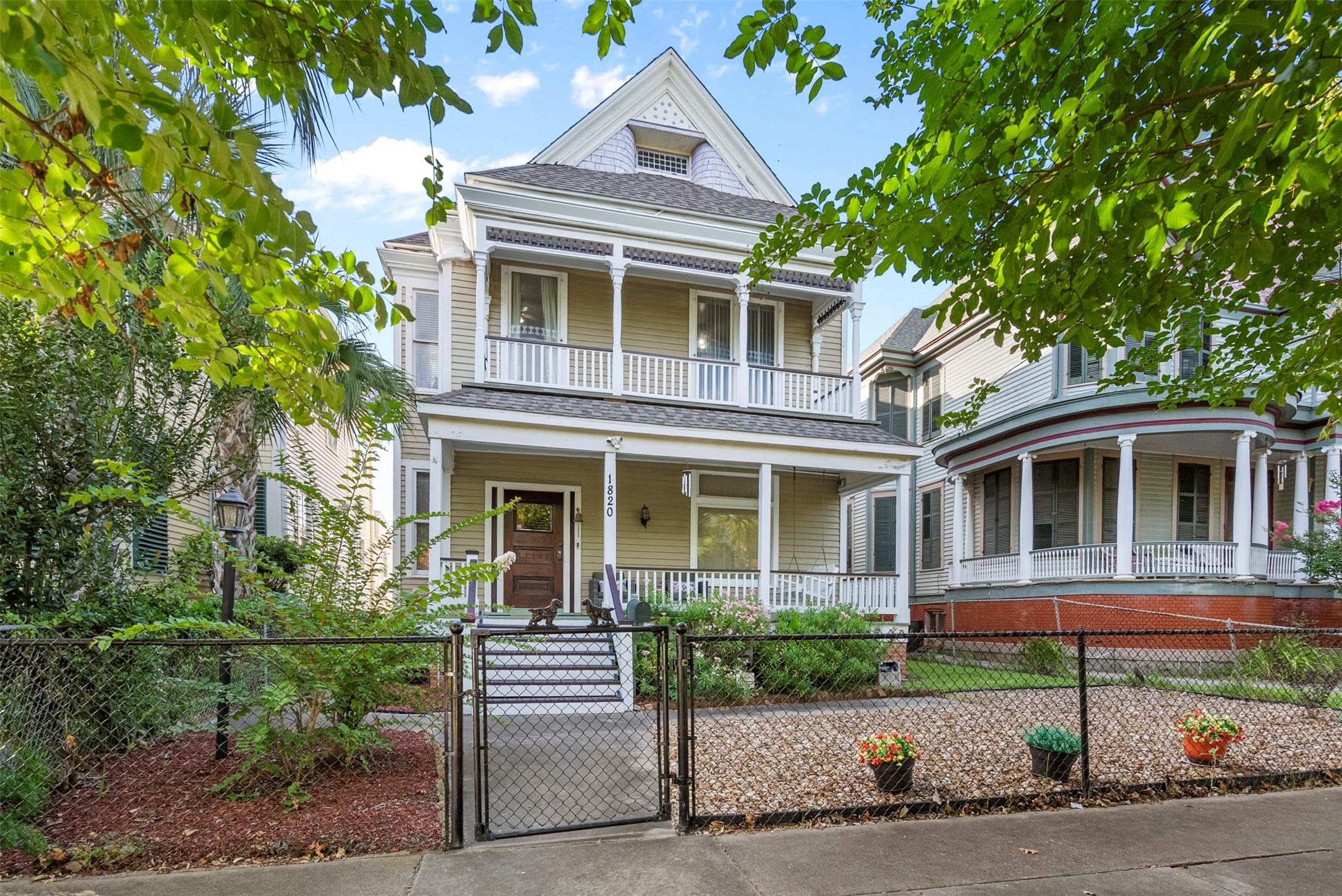 Image 2: Two-story home with a welcoming front porch, surro
