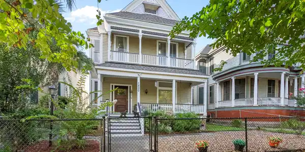 Image 2: Two-story home with a welcoming front porch, surro