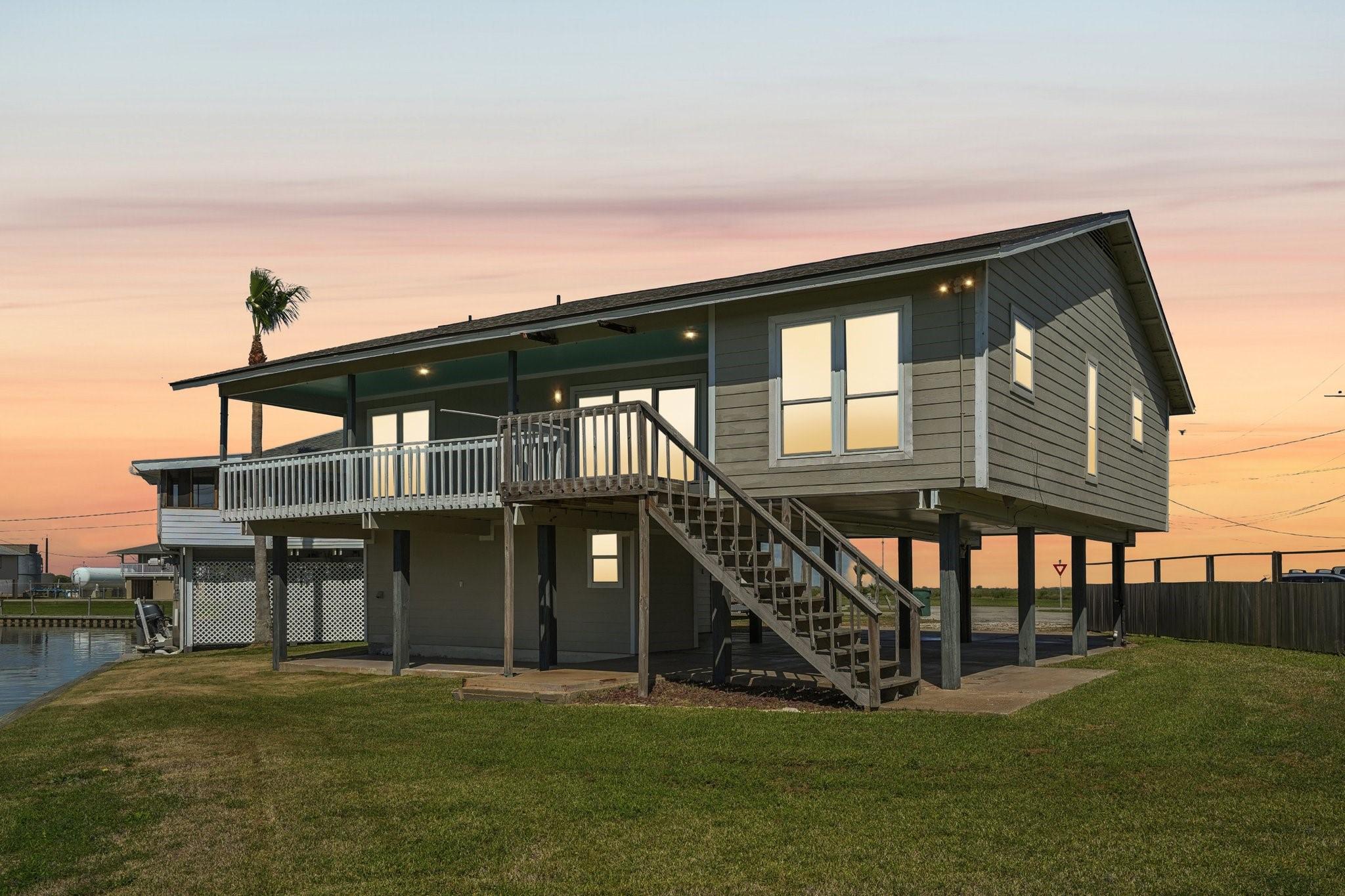 Image 2: This elevated coastal home features a spacious dec