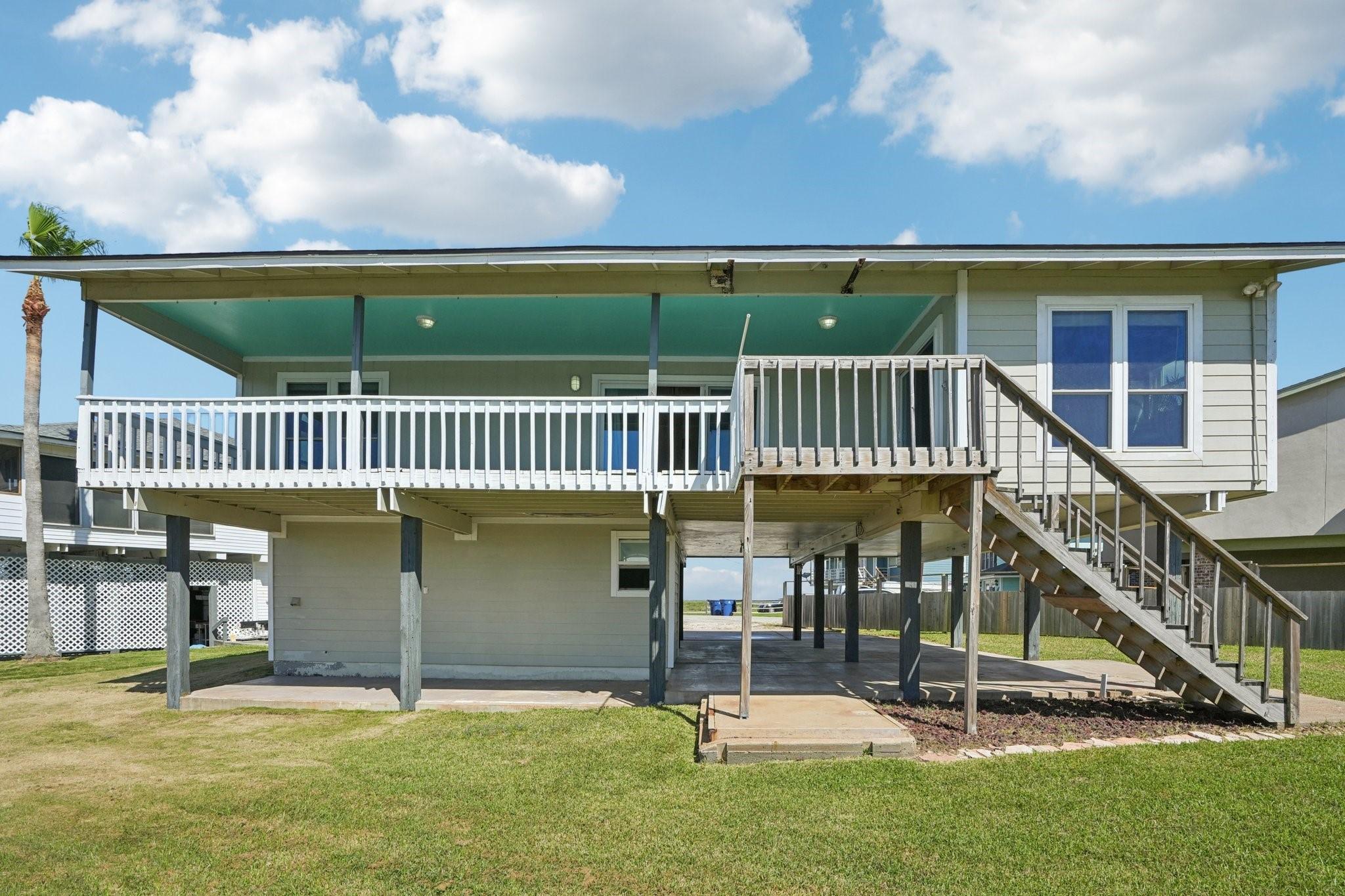 Image 3: This photo shows a raised coastal-style home with