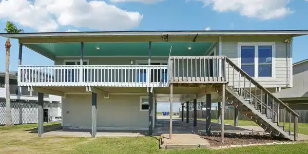 Image 3: This photo shows a raised coastal-style home with