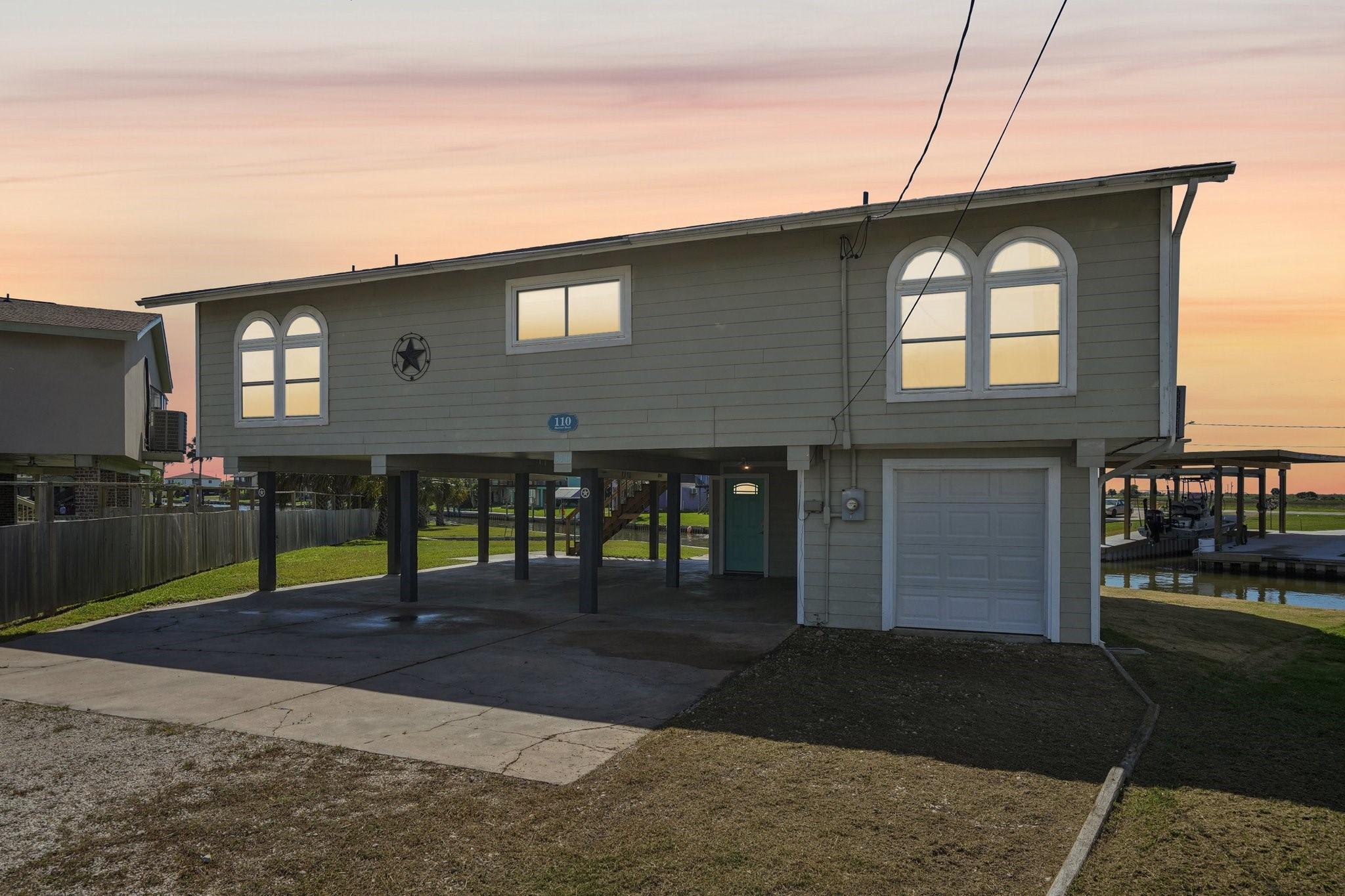 Image 4: This elevated home features a unique design with a