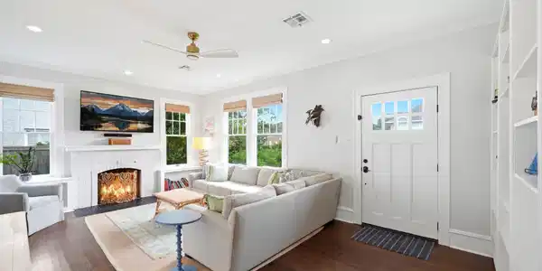 Image 3: Spacious living room with hardwood floors, large w