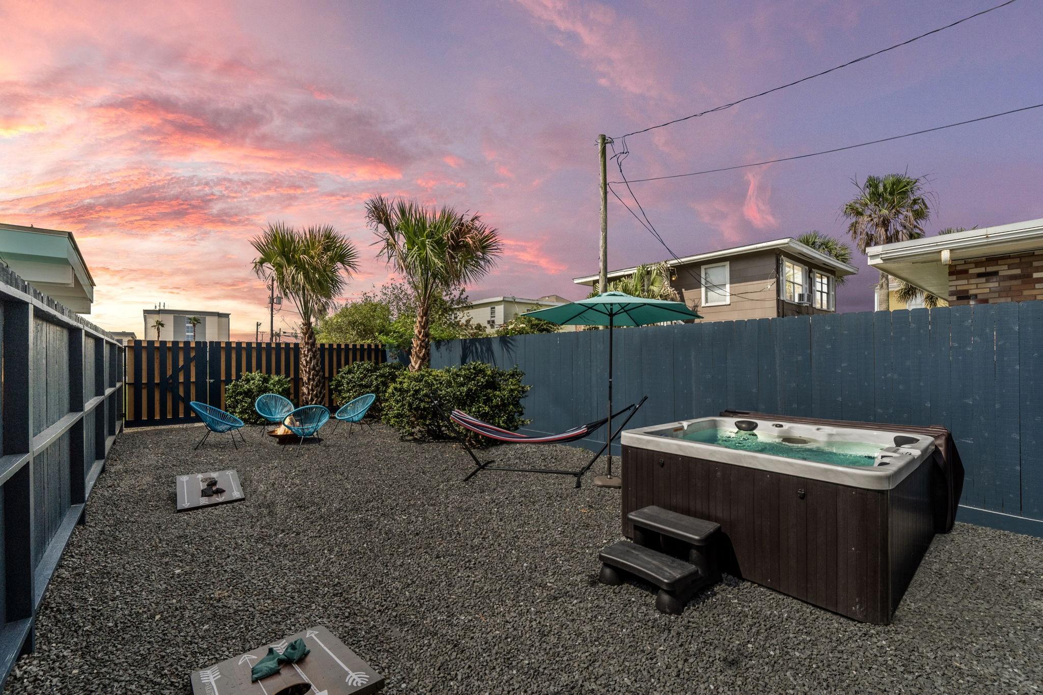 Image 2: Unit B Back Yard with hot tub and firepit