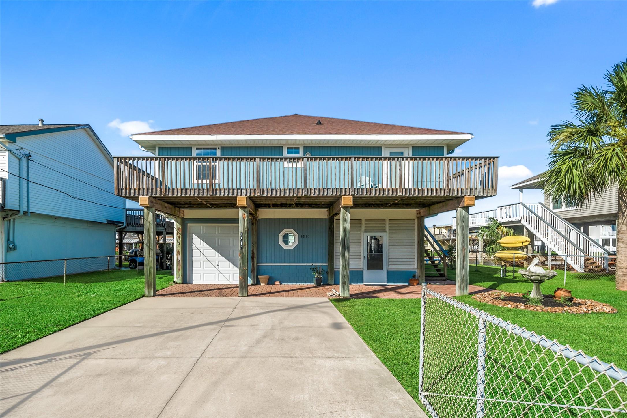 Image 3: Coastal home features a large wraparound deck, a s