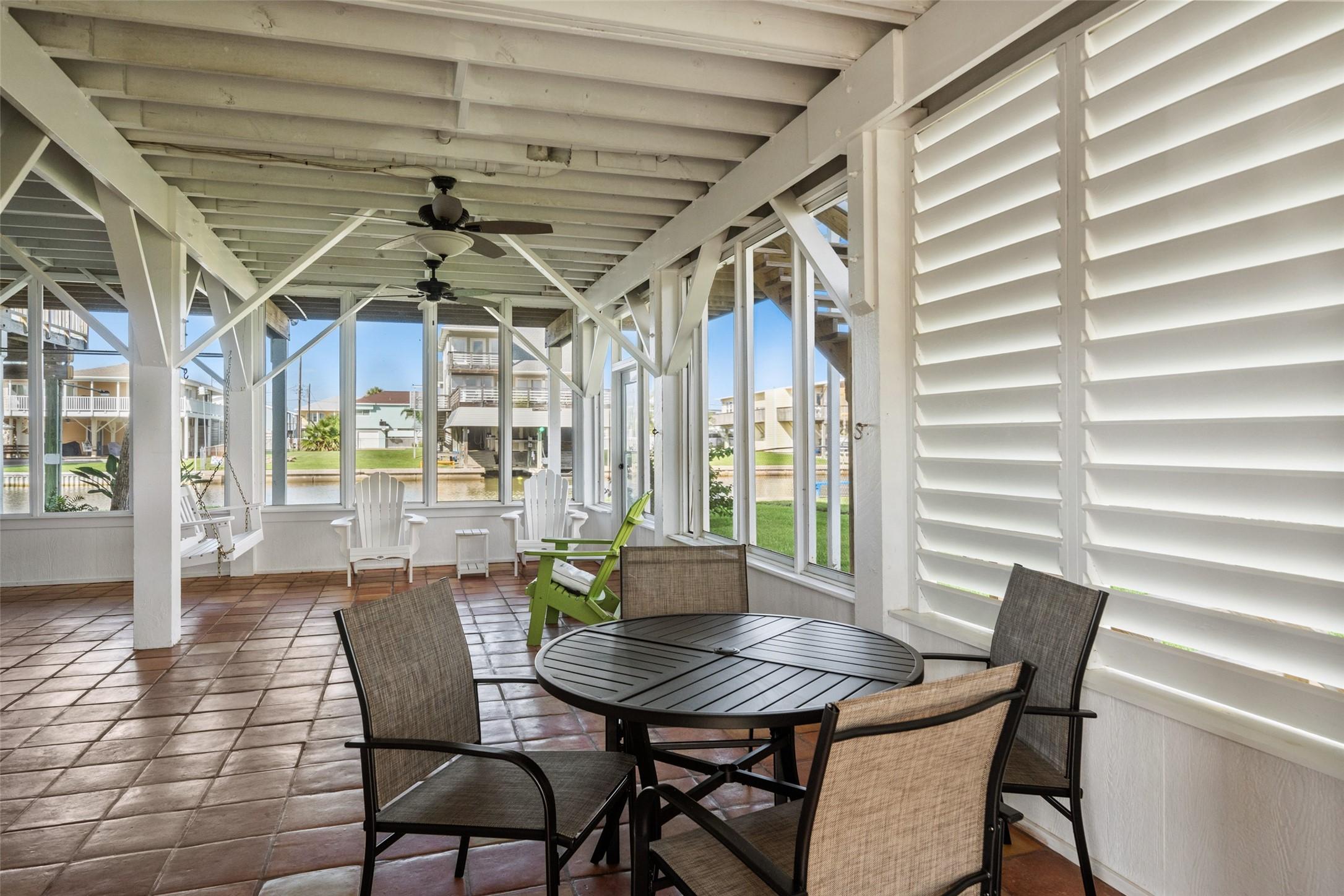 Image 4: Bright, spacious sunroom with Saltillo tile floori