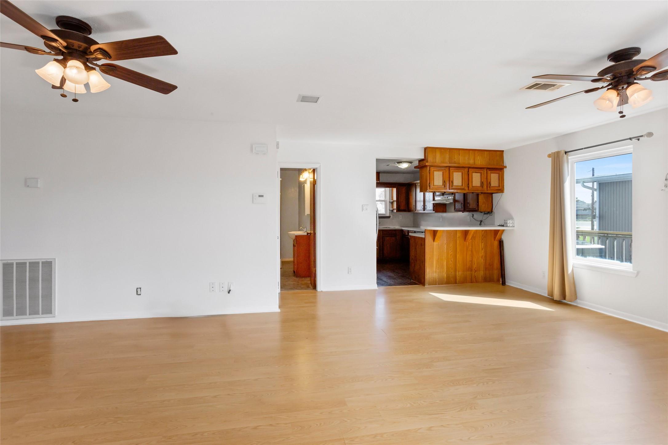 Image 3: This spacious, light-filled living area features w