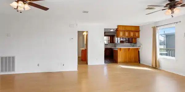 Image 3: This spacious, light-filled living area features w