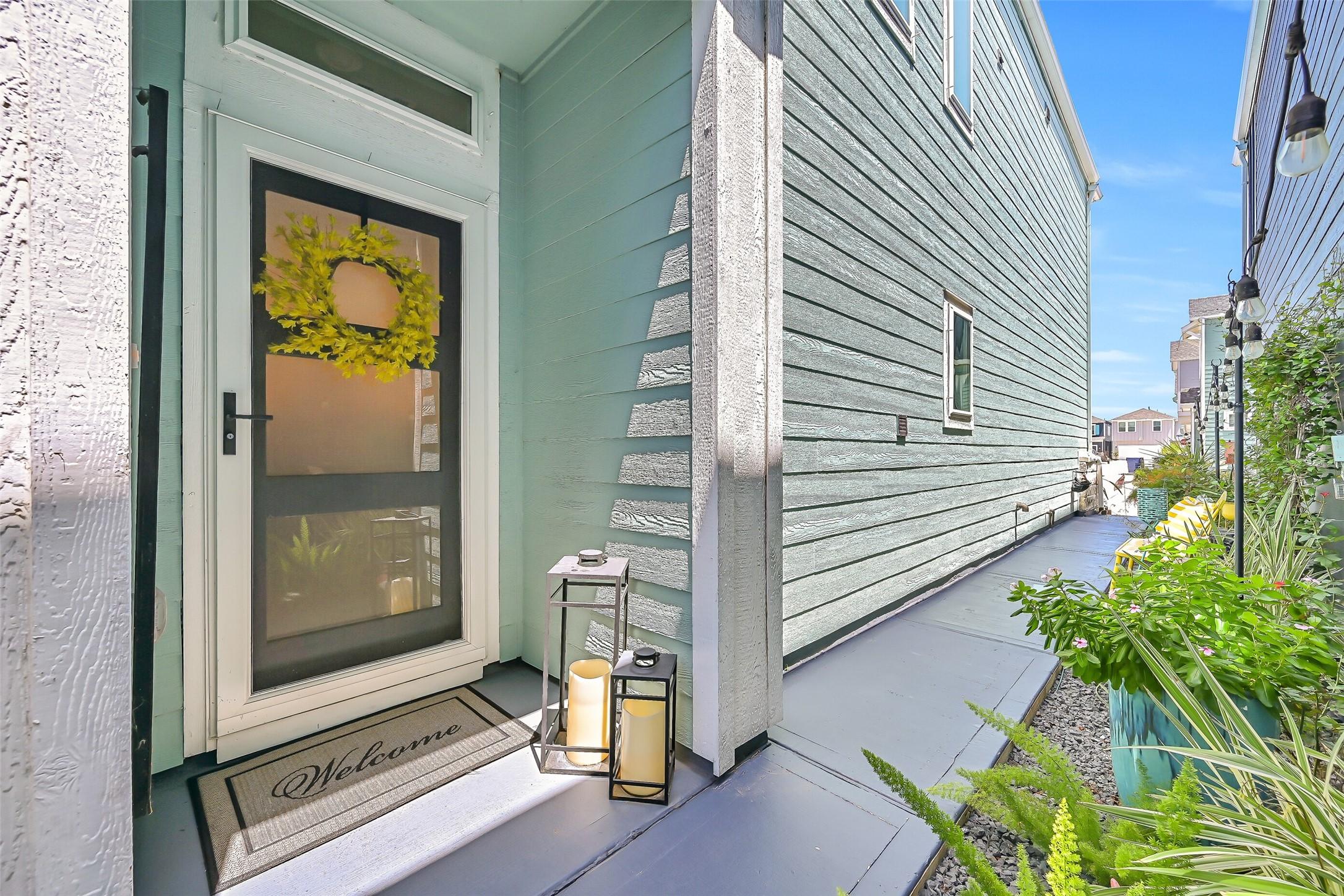 Image 3: A covered front porch with a full-view storm door,