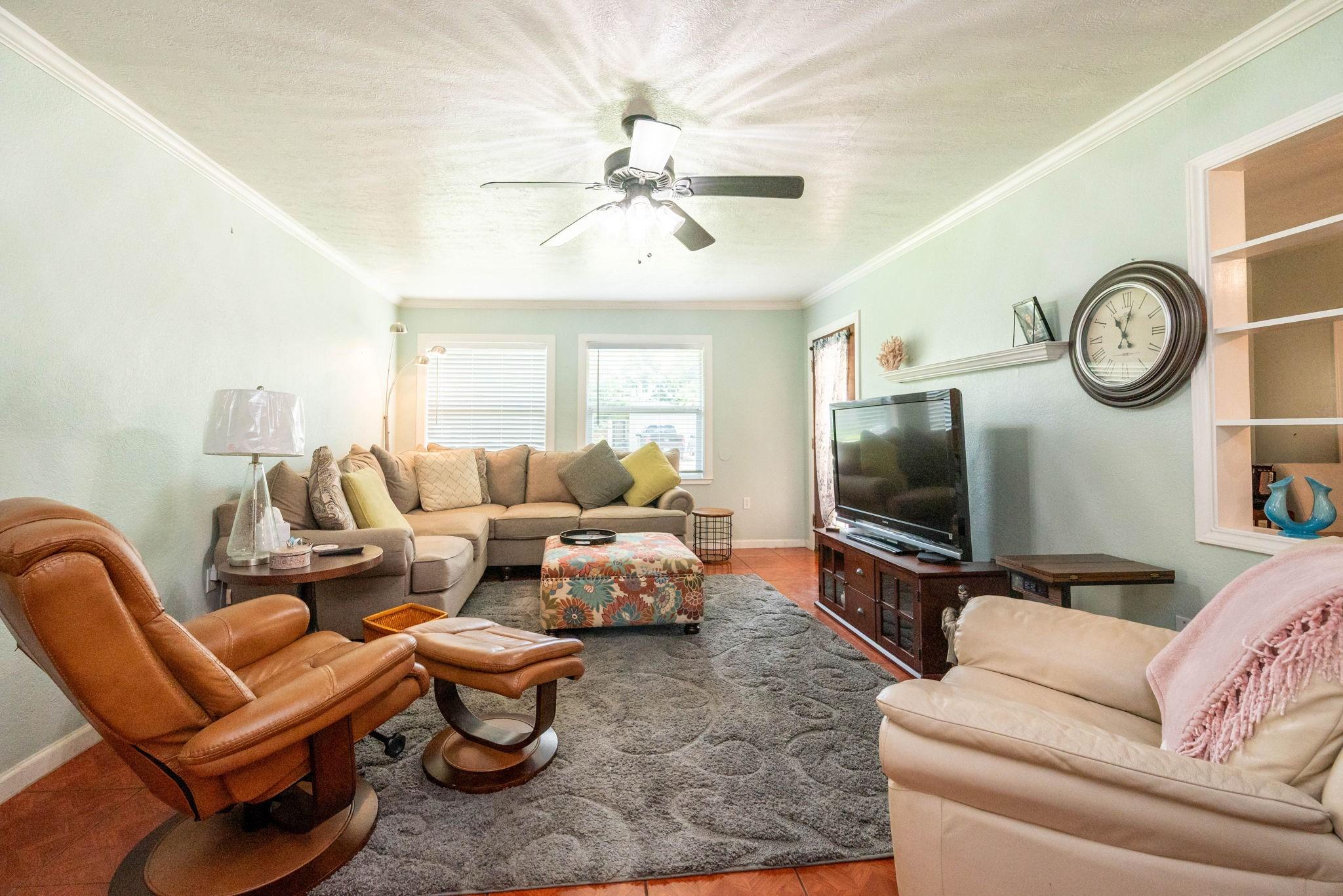 Image 1: Cozy living room with soft pastel walls. The space