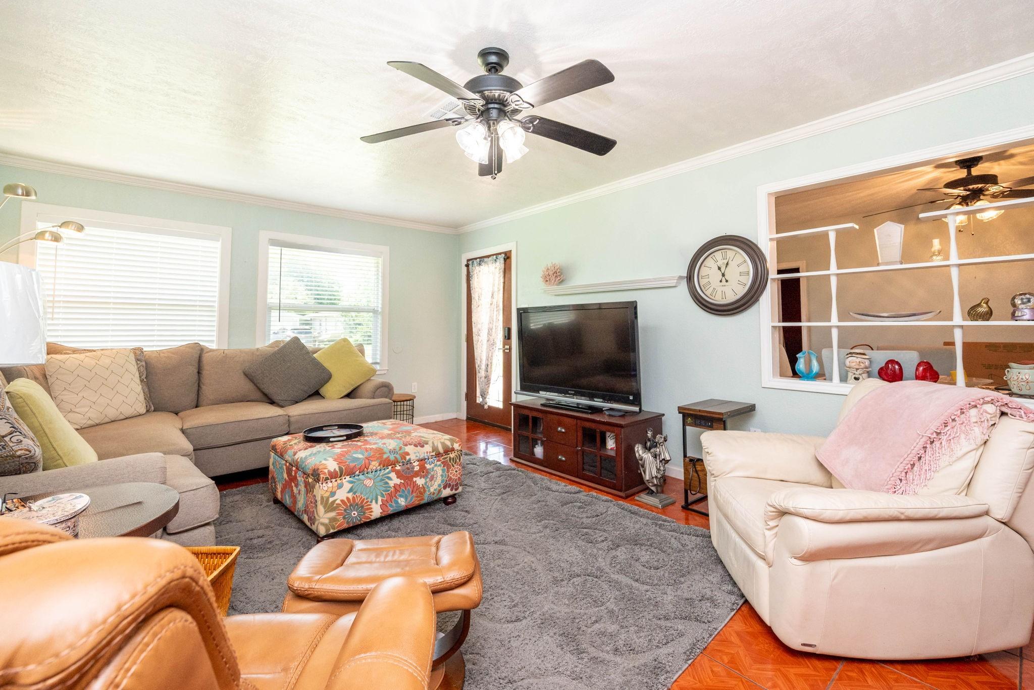 Image 2: Cozy living room with plenty of natural light. The