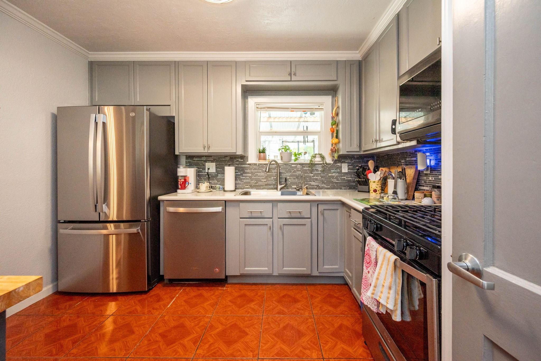 Image 4: This kitchen features modern stainless steel appli