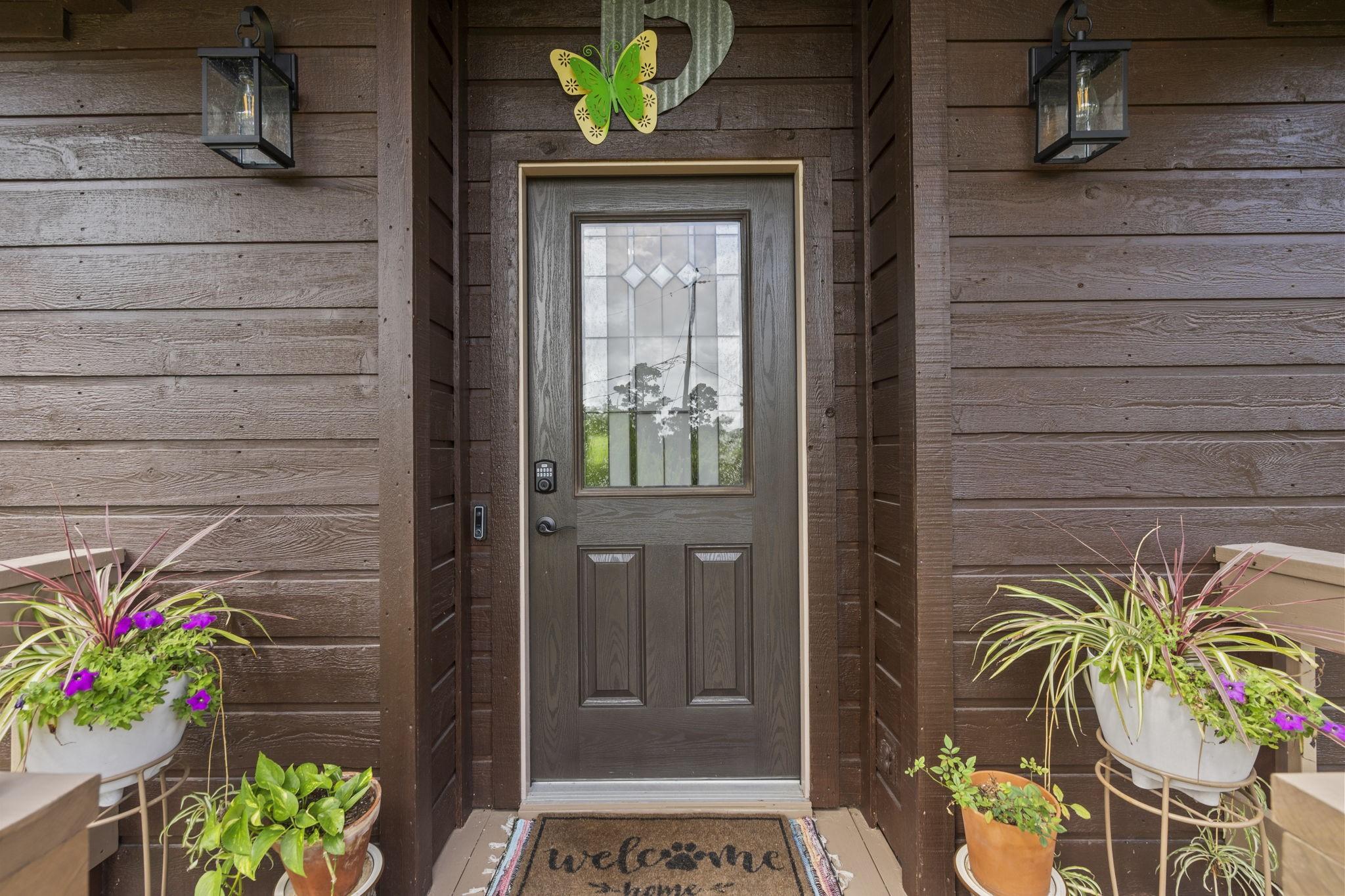Image 3: Charming front entrance with a wooden door featuri