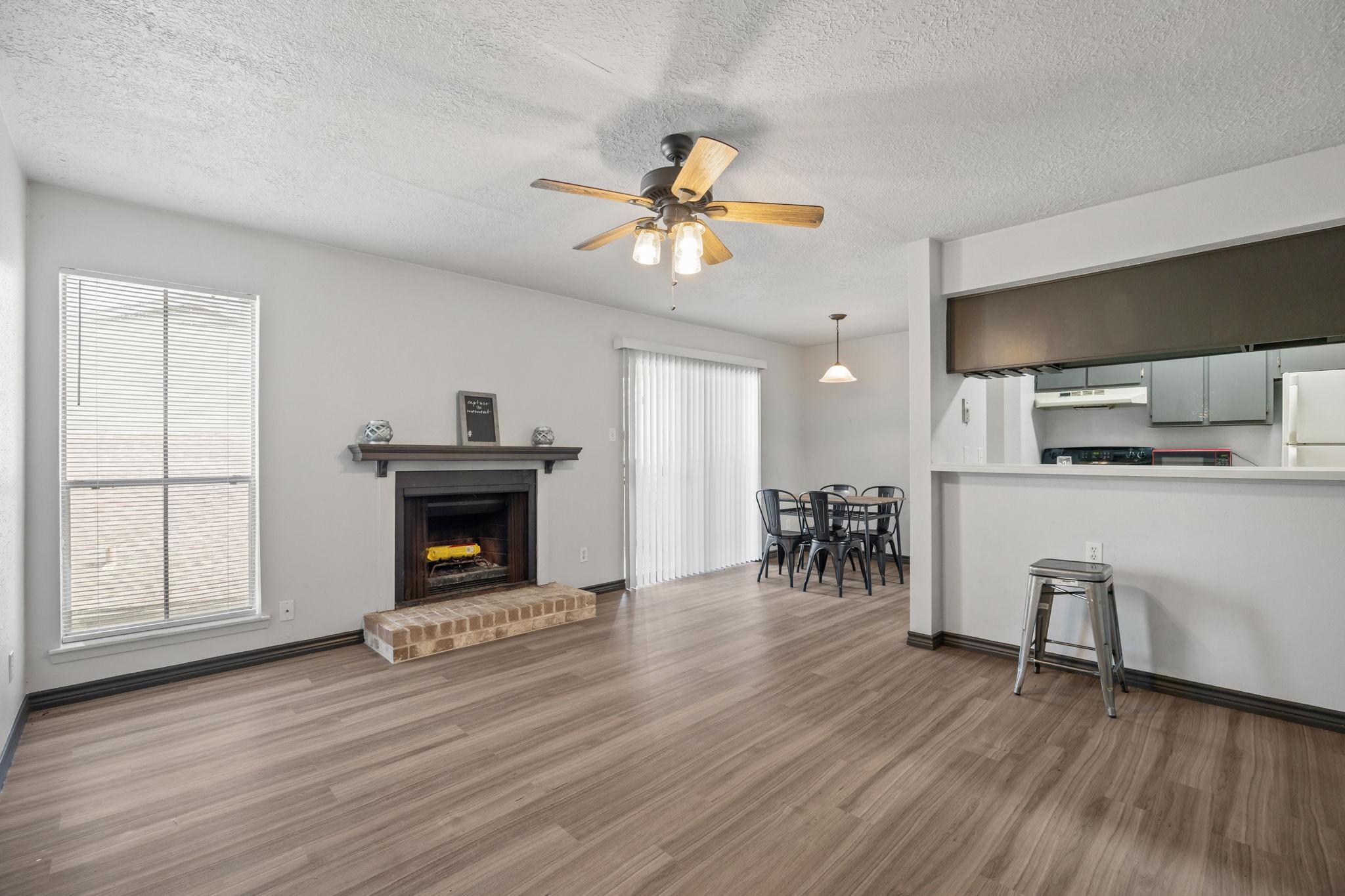 Image 1: Bright, open living area with updated flooring and