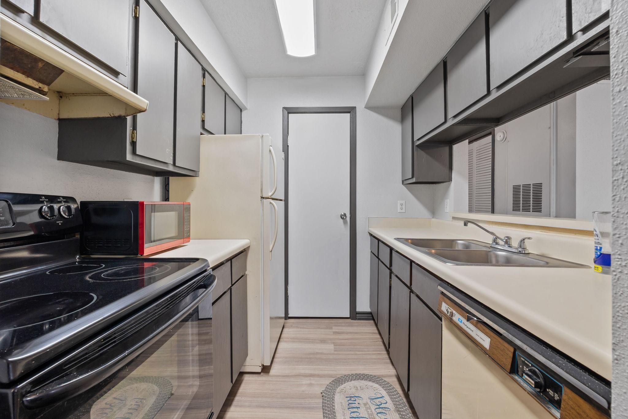 Image 4: Functional galley kitchen with ample cabinet stora