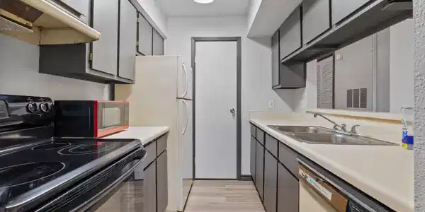 Image 4: Functional galley kitchen with ample cabinet stora