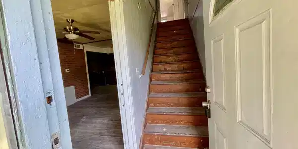 Image 3: Step into a rustic entryway featuring a wooden sta
