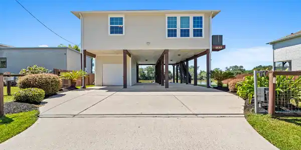Image 2: Elevated home with ample parking space underneath,