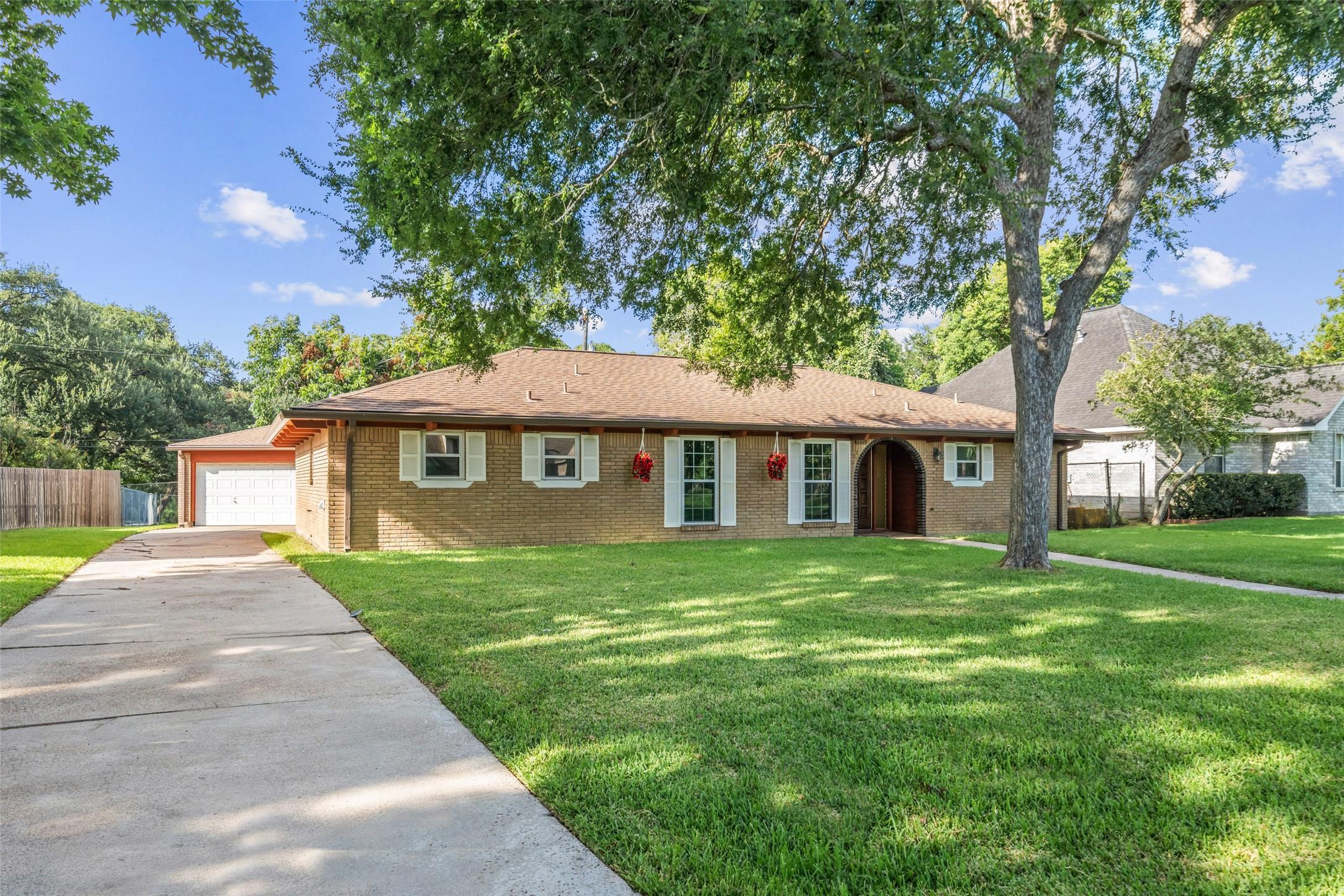 Image 3: Fully brick home with an extended driveway and det