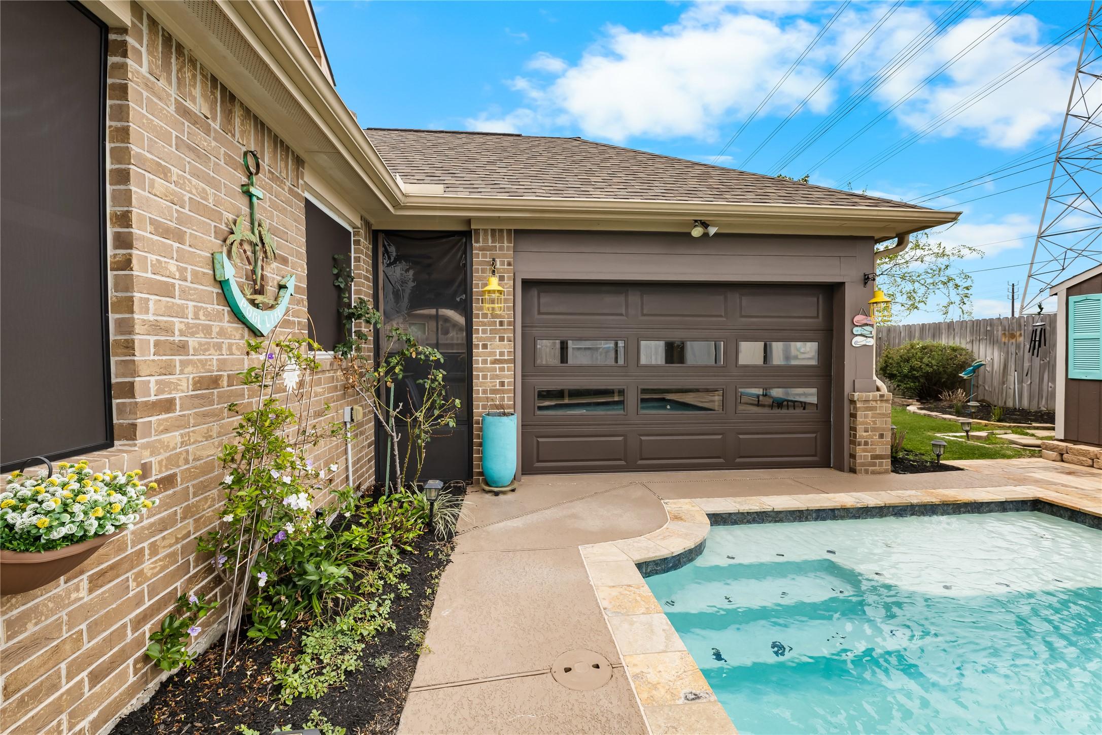 Image 4: Charming backyard featuring a cozy pool adjacent t
