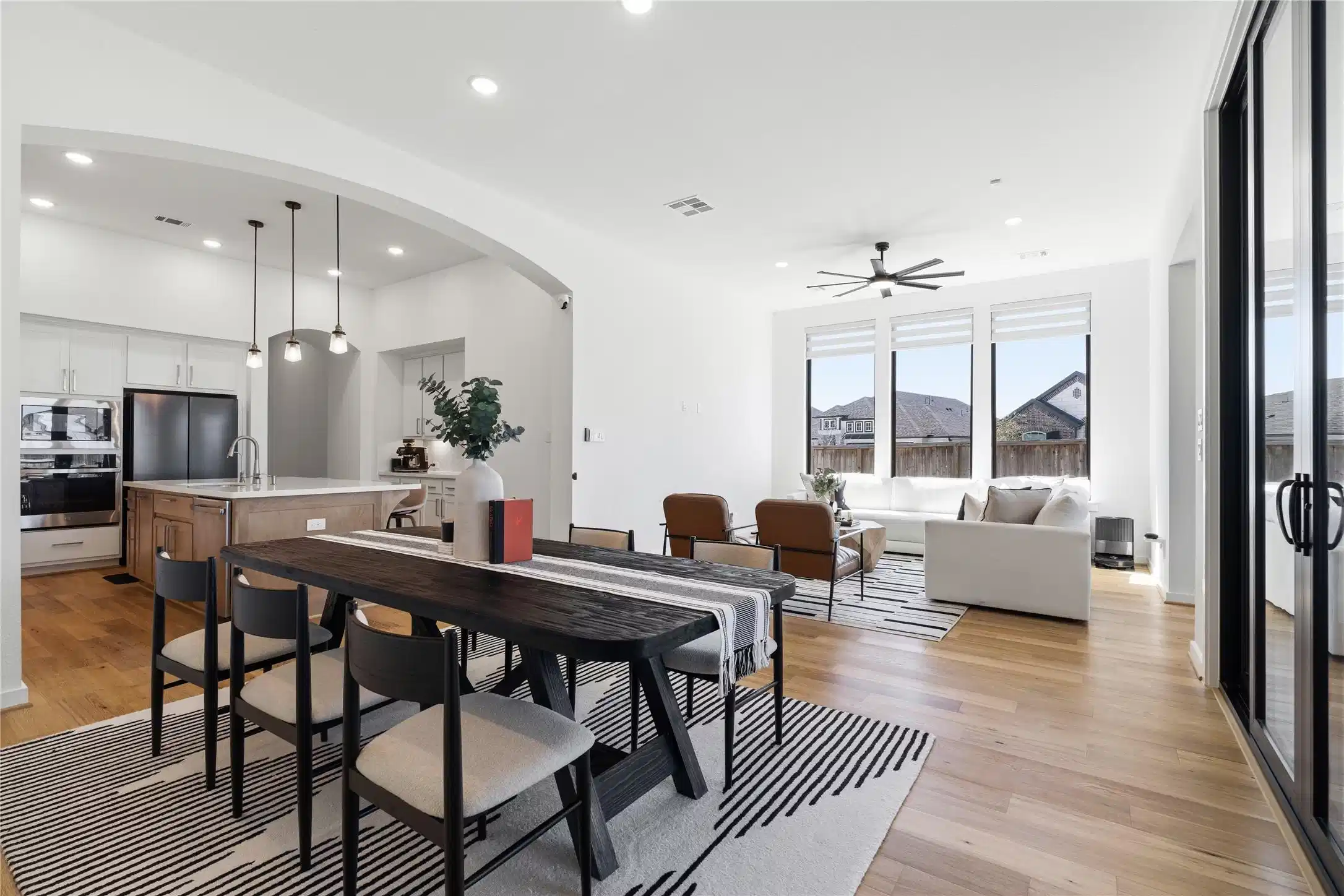 Image 1: Open-concept dining and living area with kitchen v