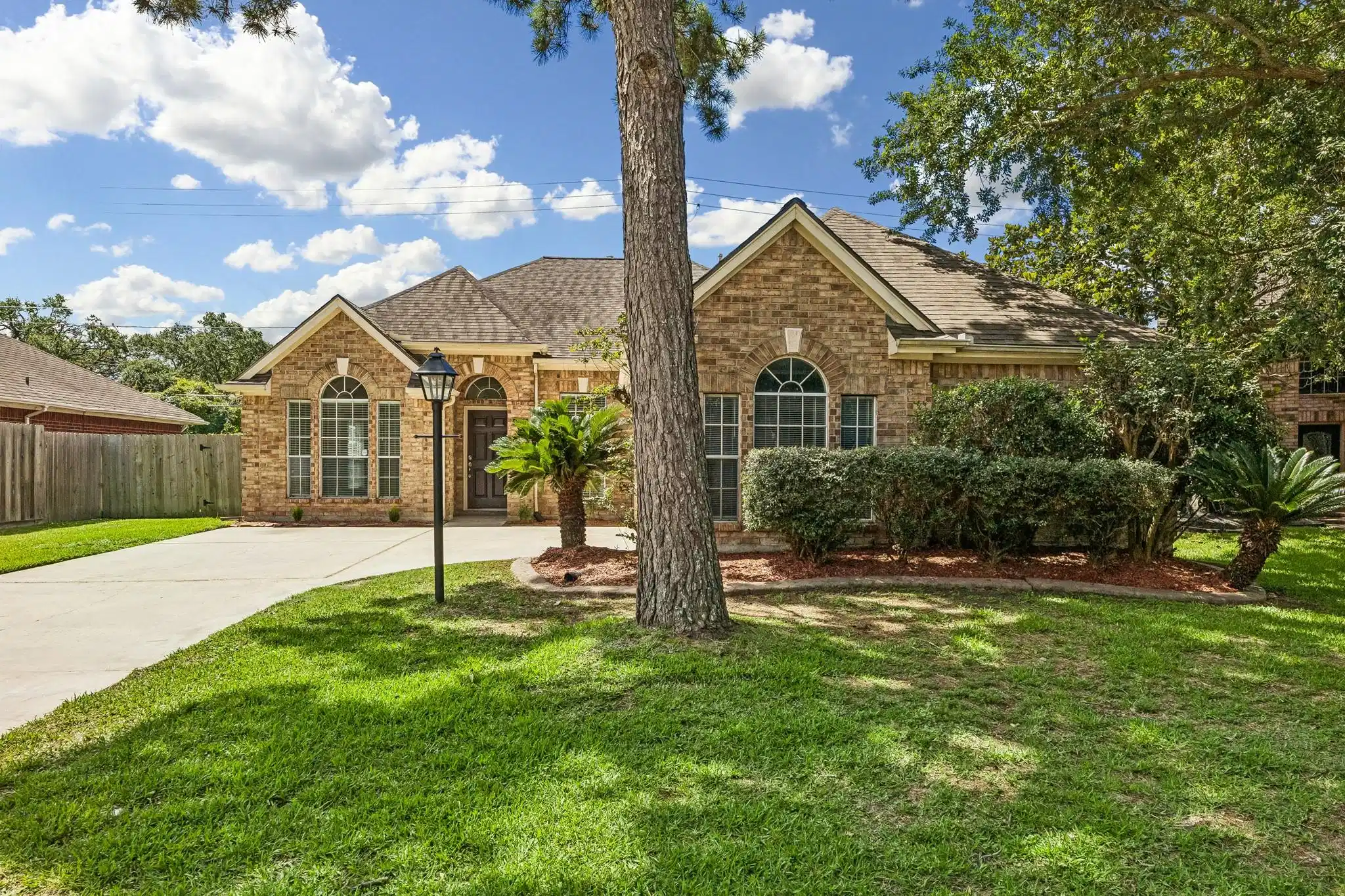 Image 1: Single story brick surround home in well establish