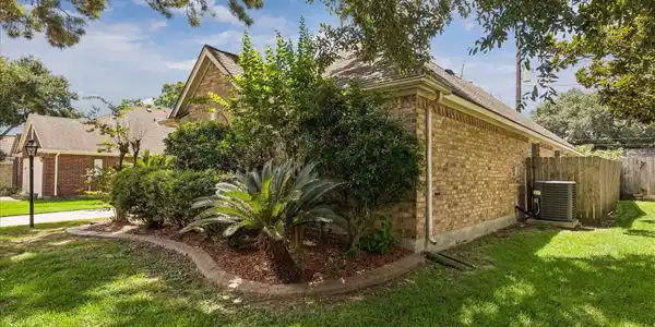 Image 4: Brick surround all sides and fully landscaped and