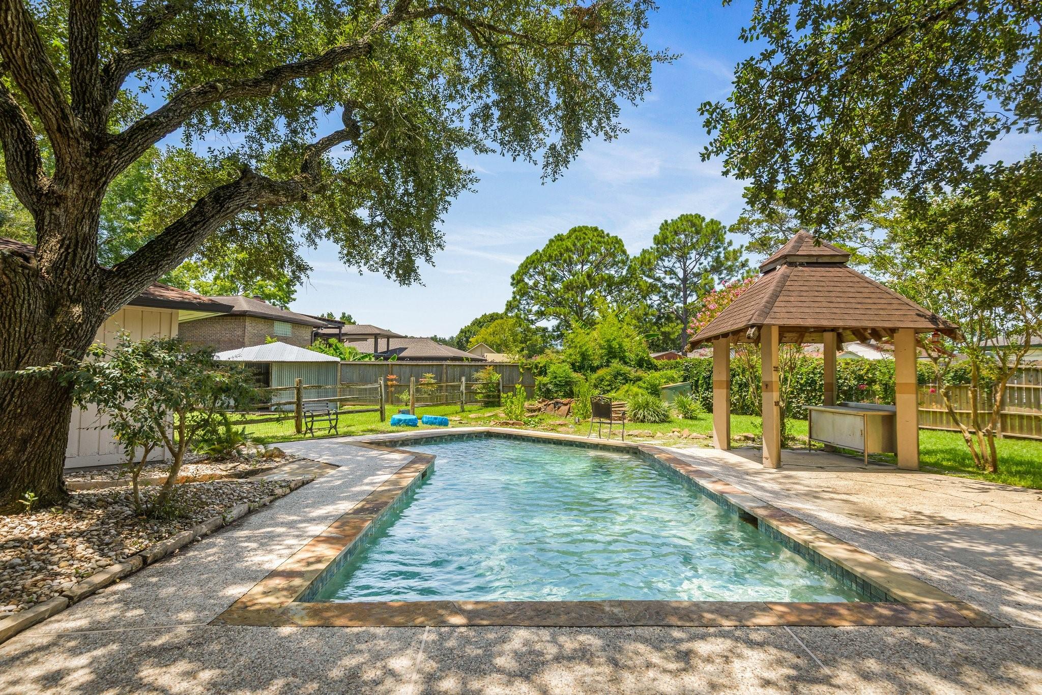 Image 2: Large gunite pool with lots of mature trees that p