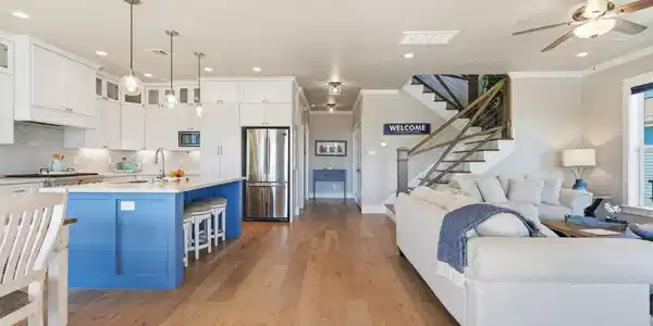 Image 3: This open-concept living area features a bright ki