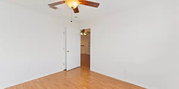 Image 2: This room features a ceiling fan with light, wood