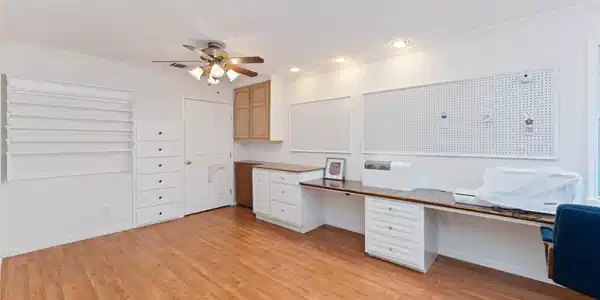 Image 3: This spacious room features a functional workspace