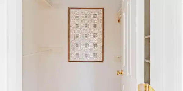 Image 4: This is a small walk-in closet with light-colored