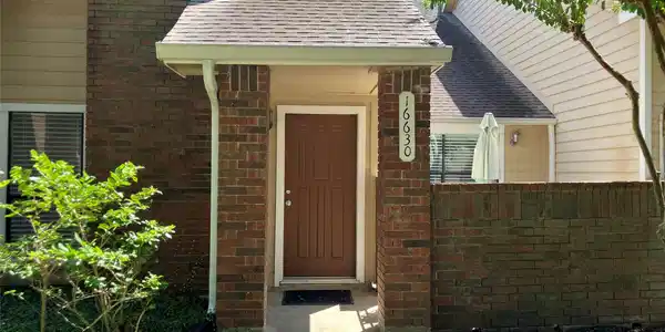 Image 2: Charming brick entryway leads to a cozy front door