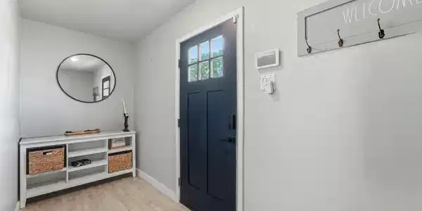 Image 3: Bright entryway with updated flooring and a welcom