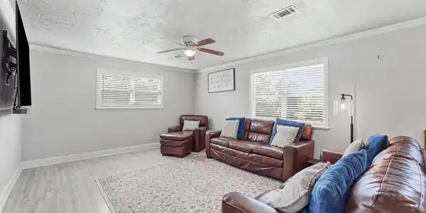 Image 4: Spacious living room with multiple windows, update