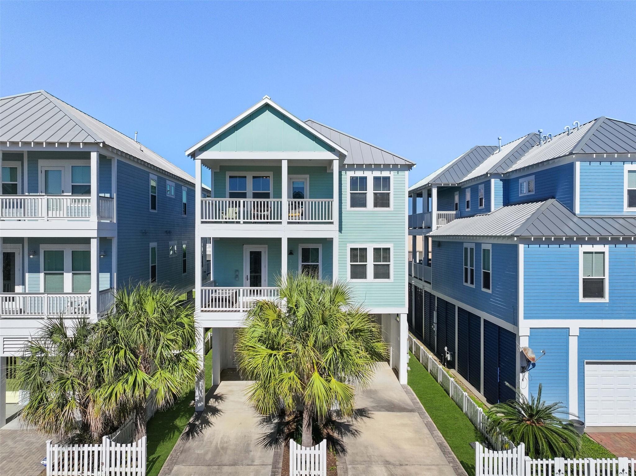 Image 2: Street view of home showcasing multiple decks and