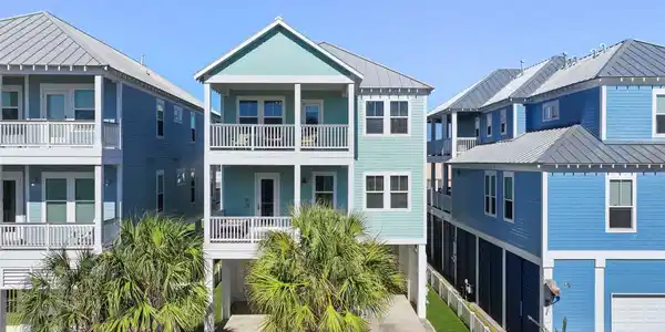 Image 2: Street view of home showcasing multiple decks and