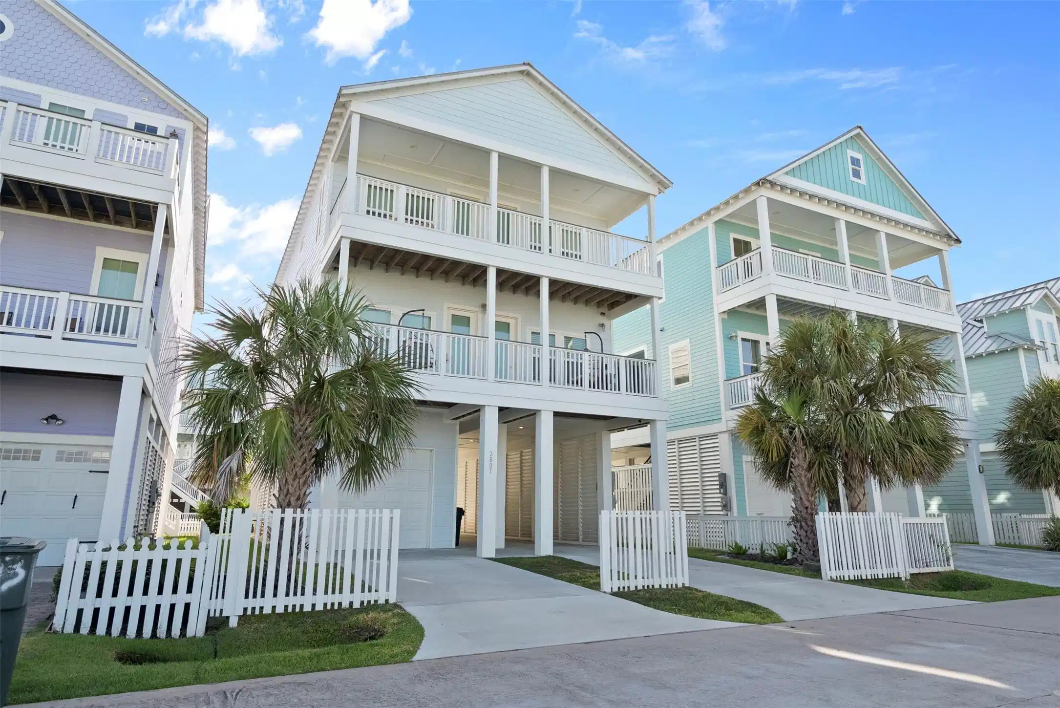 Image 1: Framed by palms and neighboring Beachside Village