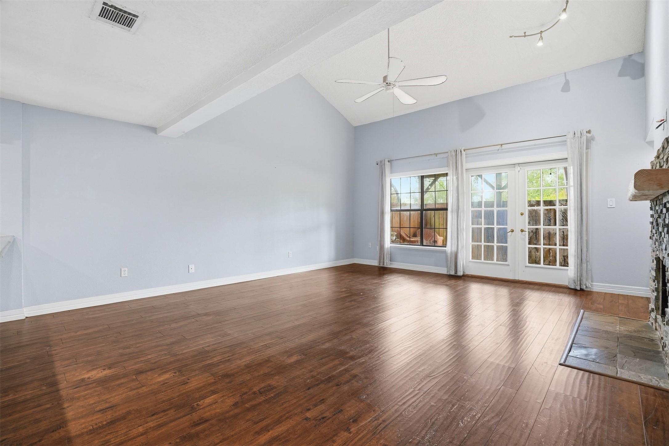 Image 3: Spacious living room featuring soaring ceilings, w