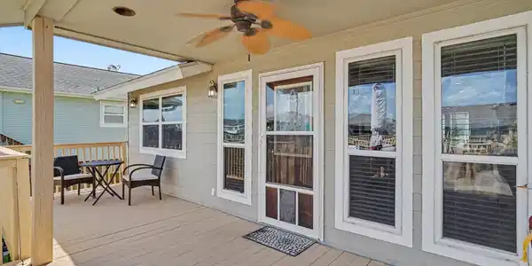 Image 4: Relax on the covered porch with a cup of coffee in
