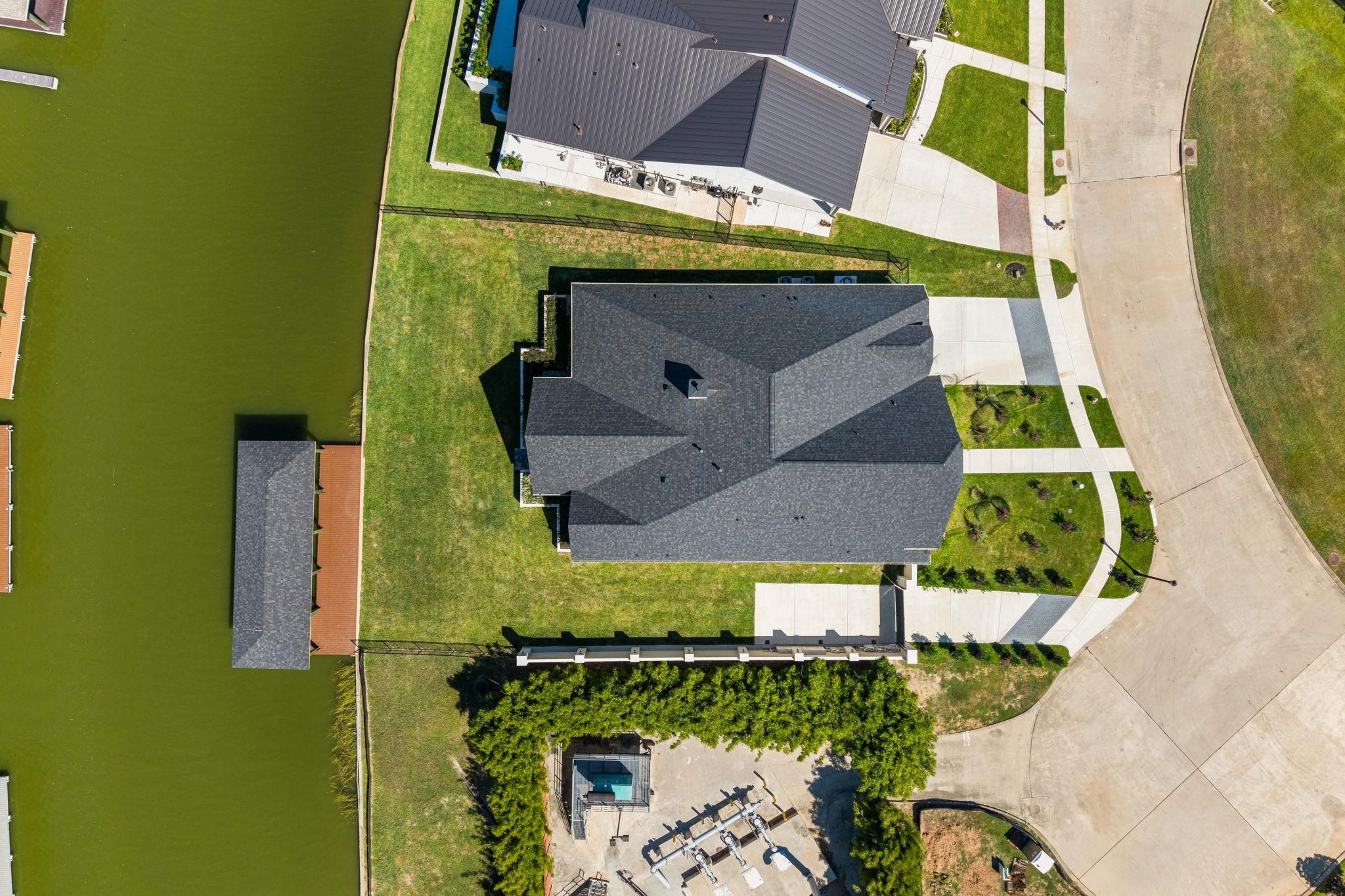 Image 4: Overhead view showing the home&rsquo;s layout, yard, and